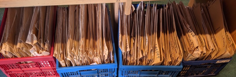 Four crates full of brown envelopes